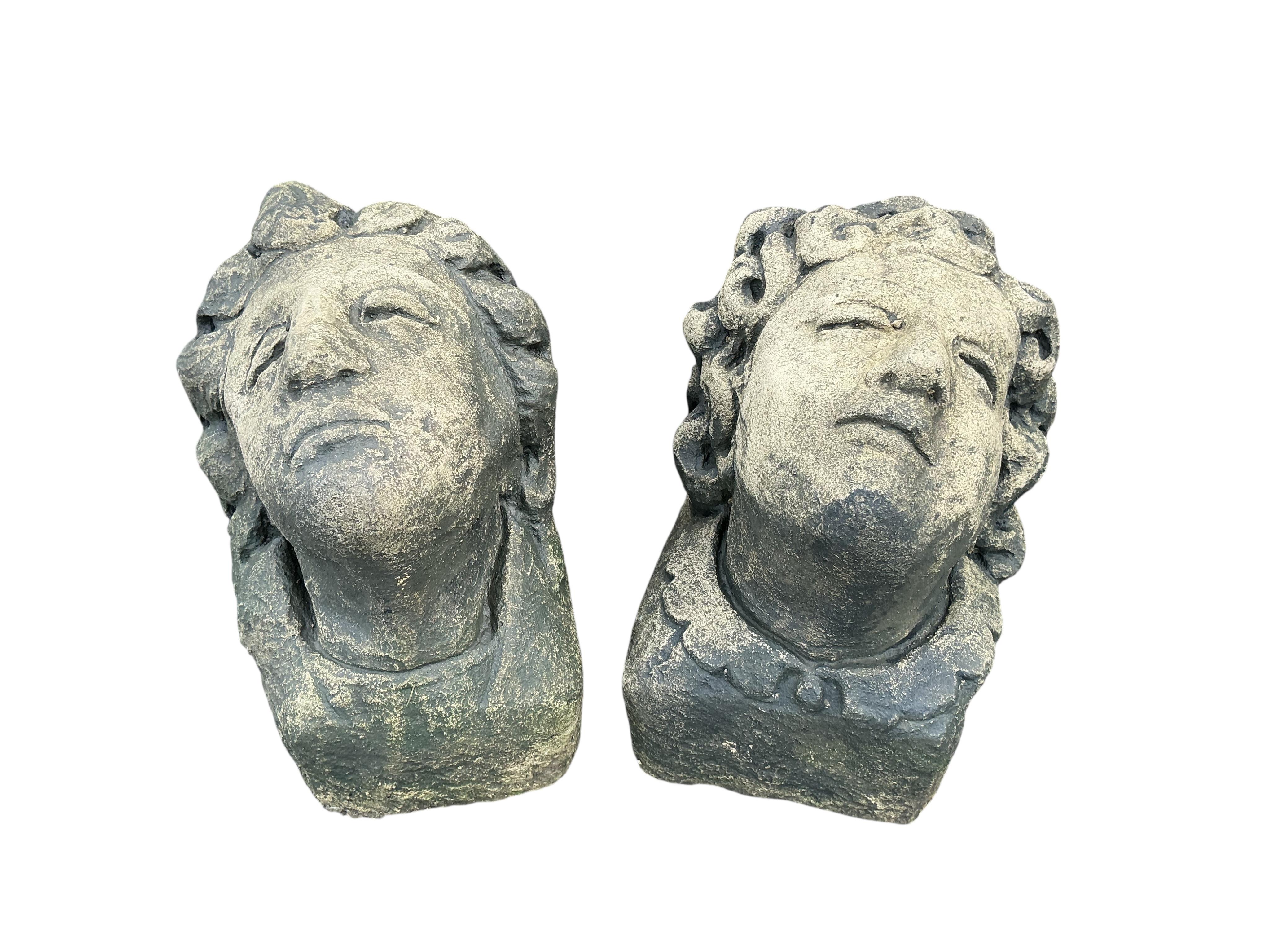 A pair of stone mask corbels, height 22cm